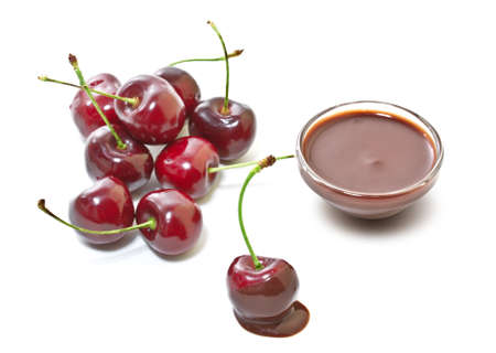 Cherries in chocolate on a white backgroundの写真素材