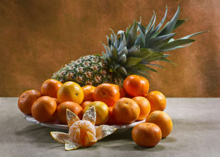 Still life with tangerines and pineappleの写真素材