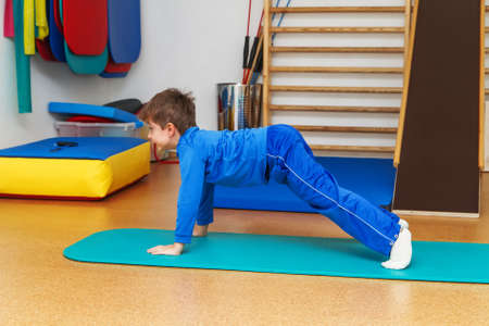 Child is therapeutic exercises in the gymの写真素材