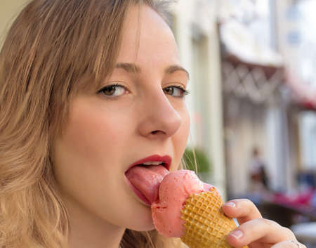 Beautiful girl eating strawberry ice creamの写真素材
