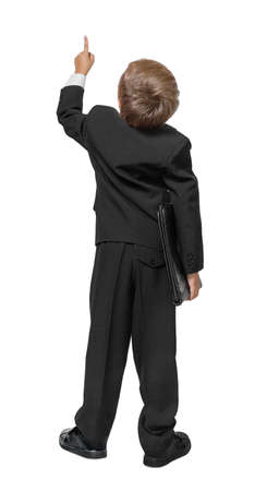 Child  in a tuxedo pointing at wall. Rear view. Isolated over white . の写真素材