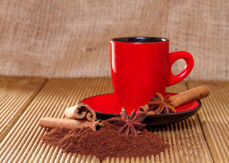 Coffee in a red cup with cinnamon and anise stars の写真素材