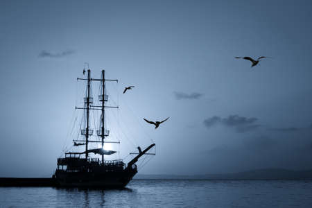 Monochrome ship silhouette at sunsetの写真素材