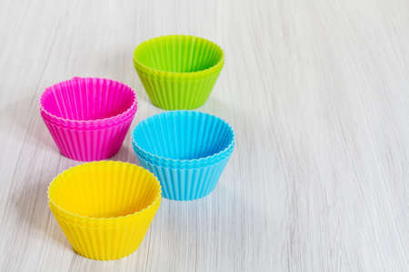 Colorful silicone baking cups on wooden background の写真素材