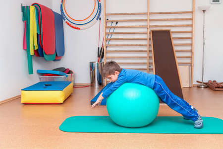 Child is therapeutic exercises in the gym の写真素材