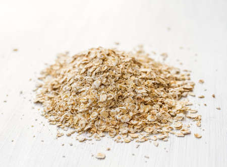 Oat flakes on a wooden tableの写真素材