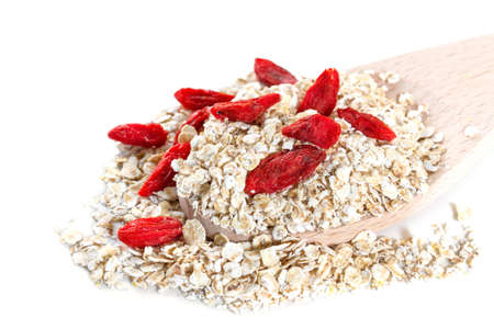 Oat flakes with goji berries on white backgroundの写真素材