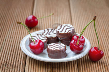 Swiss cookies with ripe cherriesの写真素材