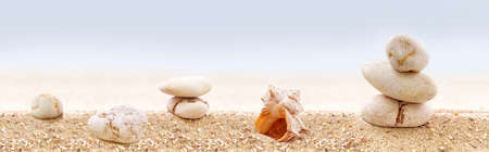 Panorama of zen stones on a sandy beach  の写真素材