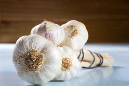Head of garlic on a wooden backgroundの写真素材