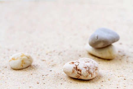 Stack of  stones on sand beach の写真素材