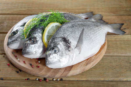 Fresh Dorado on a wooden background の写真素材