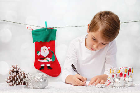 Boy writes a letter to Santa Claus.の写真素材