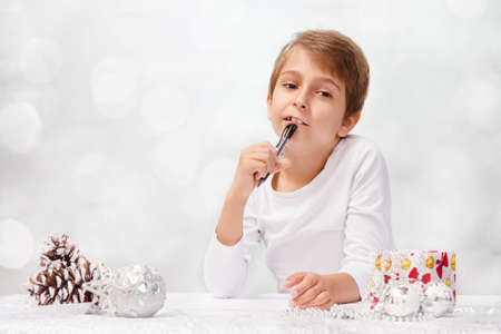 Boy writes a letter to Santa Claus.の写真素材