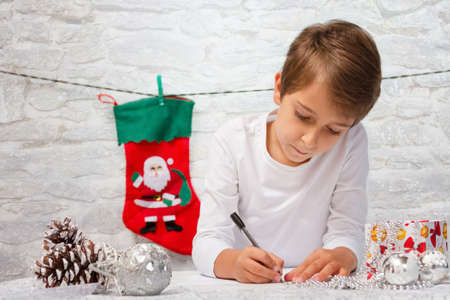 Boy writes a letter to Santa Claus.の写真素材