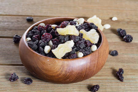 Mixed nuts with raisins close up on a wooden backgroundの写真素材