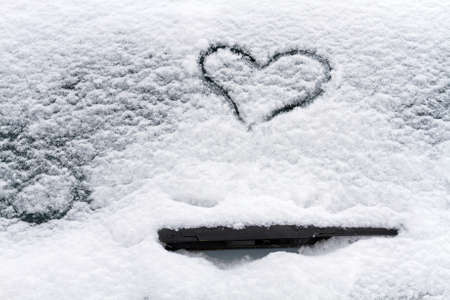 Heart symbol on a car windshield.