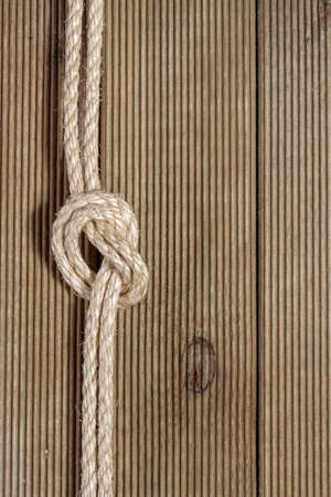 Wooden background with rough ropeの写真素材