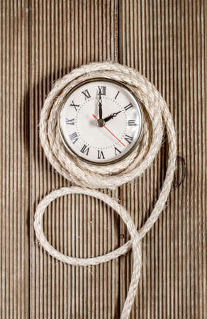 Retro clock on a wooden backgroundの写真素材