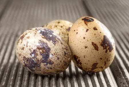 Quail eggs on wooden background closeup.の写真素材
