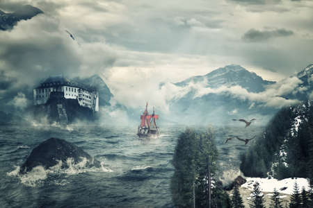 Mystical landscape with peaks of mountains and the sea.の写真素材