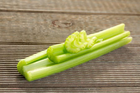 Fresh celery stalks on a wooden tableの写真素材