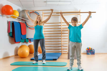 Happy, sports family, mother and son perform gymnastic exercises.の写真素材