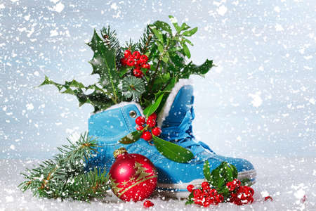 Blue shoe with Holly leaves and berries. Christmas backgroundの写真素材