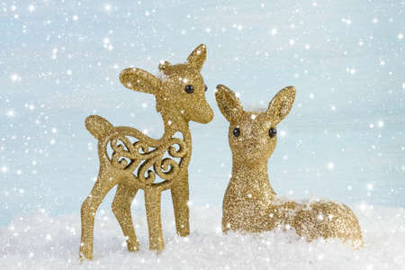 Family of deer in the snow. Christmas background.の写真素材