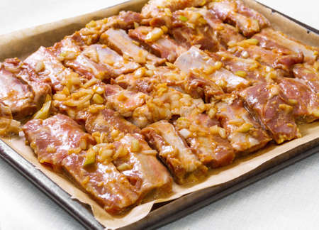 Marinated pork ribs ready for roasting. Step on step recipe.の写真素材