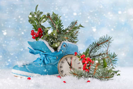 Christmas clock with boots and Holly leavesの写真素材