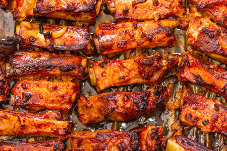 Grilled pork ribs on a baking sheet. Step on step recipe.の写真素材