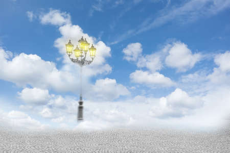Surreal image of a street lamp in the cloudsの写真素材
