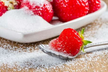 Ripe strawberry in sugar closeupの写真素材