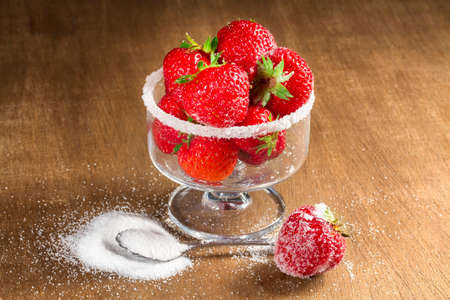 Ripe strawberry in sugar closeupの写真素材