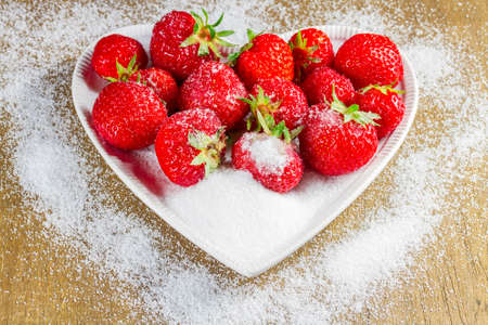Ripe strawberry in sugar closeupの写真素材