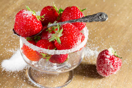 Ripe strawberry in sugar closeupの写真素材