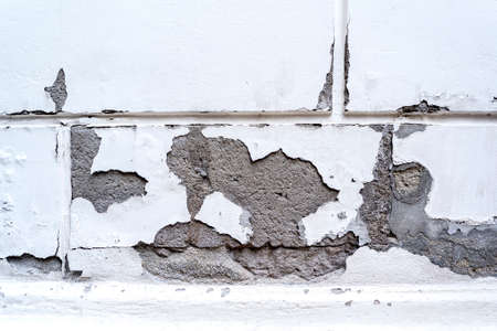 Old wall with damaged plaster layerの写真素材