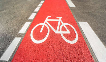 Red bicycle path with a bicycle symbolの写真素材