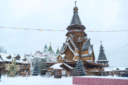 Wooden church inside the iconic complex "Kremlin in Izmailovo" aka Izmailovskiy Kremlin  in winter snow, a cultural center in Moscow, Russiaの写真素材