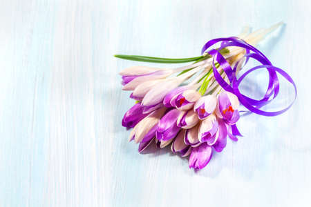 Bouquet of crocuses on a wooden tableの写真素材