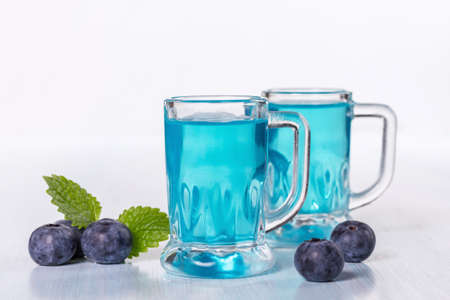 Liqueur of blueberries with fresh berriesの写真素材