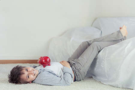 School boy with piggy bankの写真素材