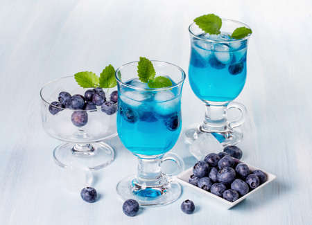 Alcoholic cocktail with blueberries and mint. Space for textの写真素材