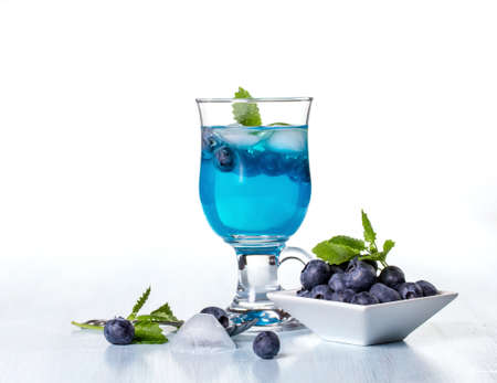 Alcoholic cocktail with blueberries and mint. Space for textの写真素材