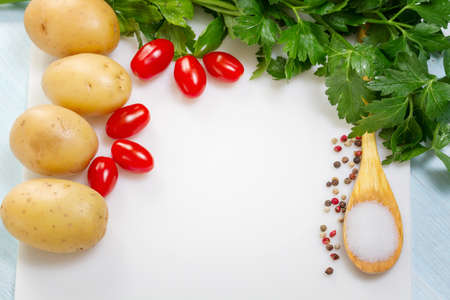 Food background with potatoes, parsley and spices. Place for textの写真素材