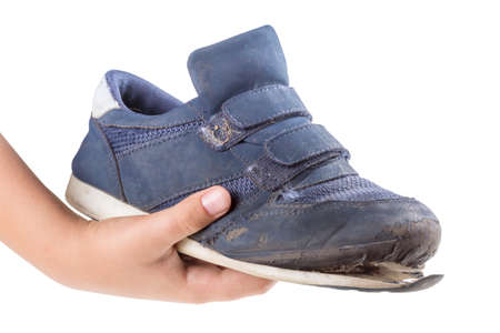 Old, worn sneakers on white backgroundの写真素材