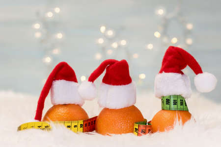 Christmas background with tangerines and measuring meter. Concept of the Christmas dietの写真素材