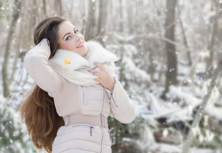 Beautiful young woman in winter forestの写真素材
