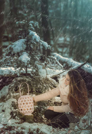 Beautiful young woman in winter forestの写真素材